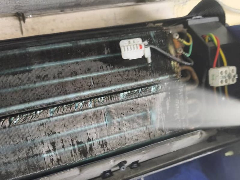 Serpentín de un split cubierto de moho negro antes de lavarlo.